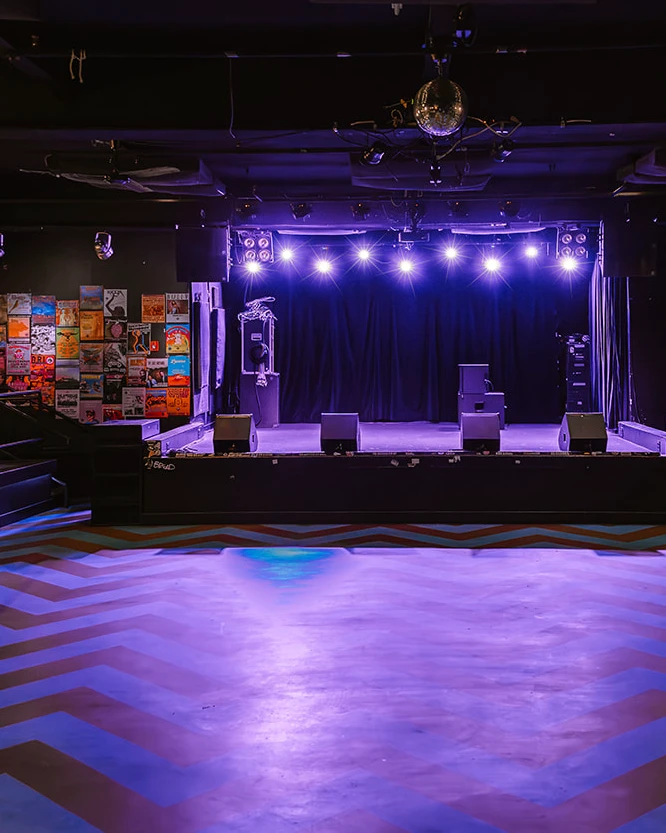 venue area with open floor, stage, and seating area to one side