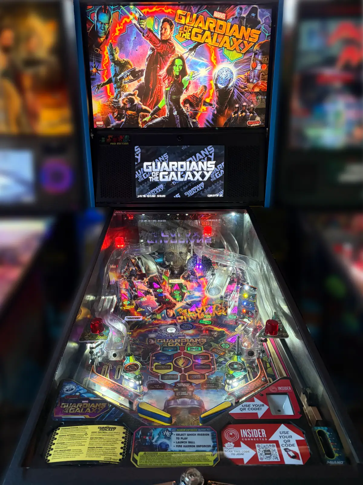A brightly lit, colorful Guardians of the Galaxy pinball machine. The backglass displays the main movie characters over the illuminated playfield.