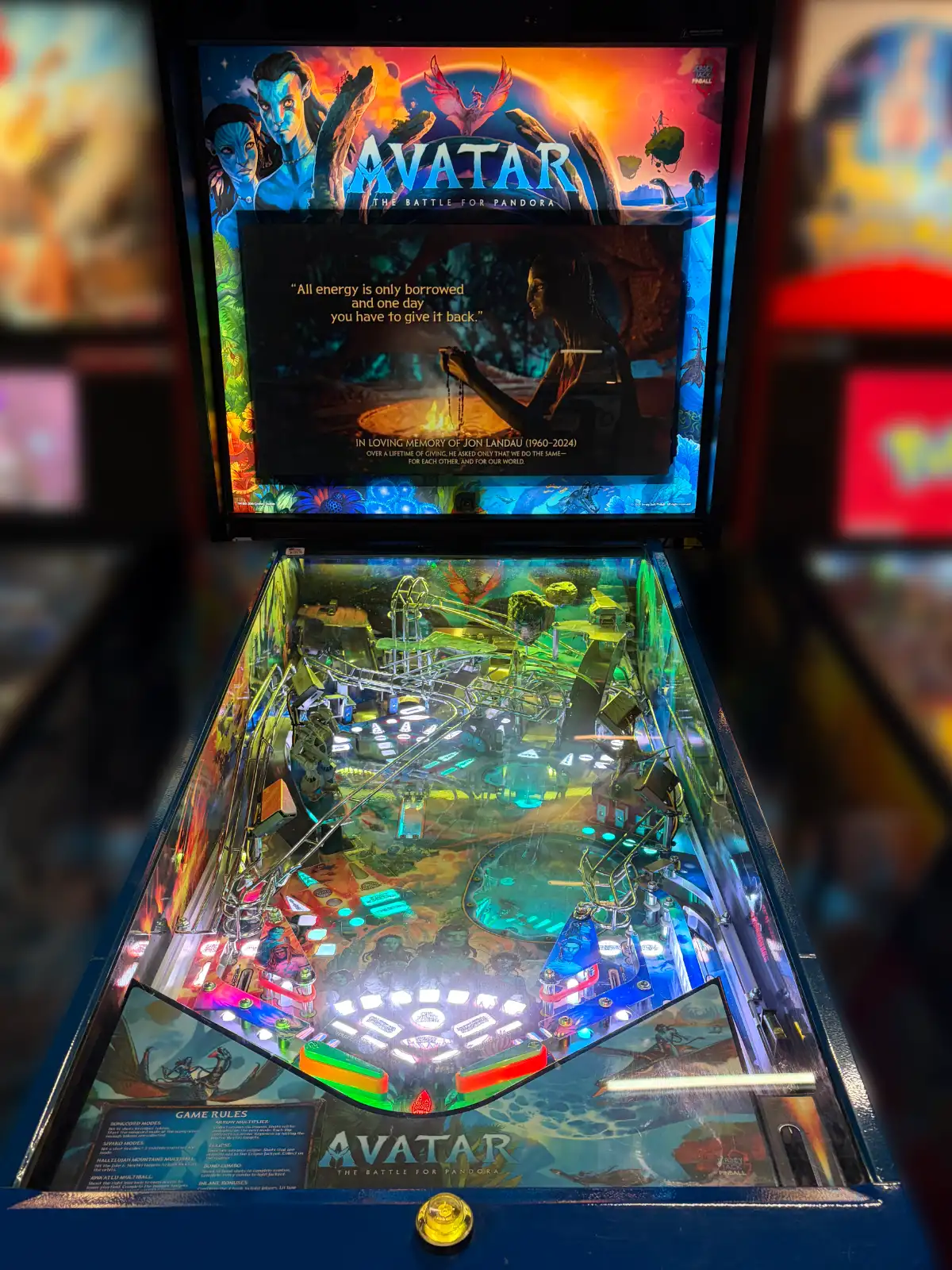 A brightly lit, colorful pinball machine themed after Avatar: The Battle for Pandora. The backbox displays Na'vi characters above the complex, active playfield.